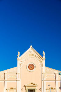 Low angle view of building against clear blue sky