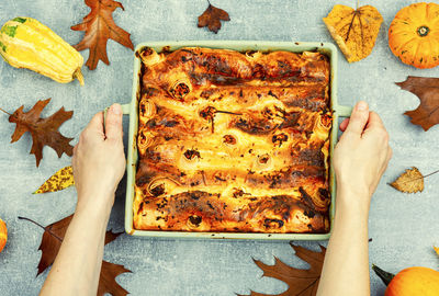 Pumpkin baked with cottage cheese in pita bread, appetizing autumn tart in hands