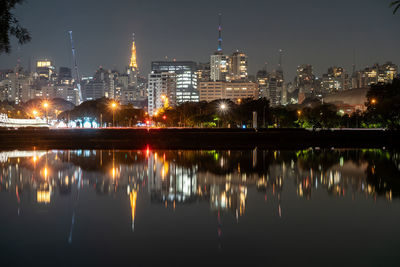 Reflection of illuminated buildings in city at night