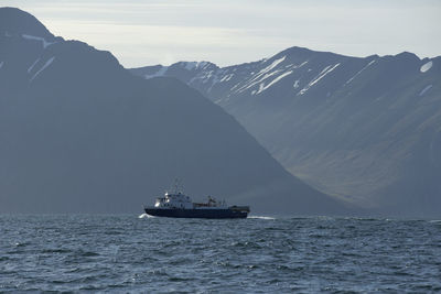 Boat sailing on sea against sky