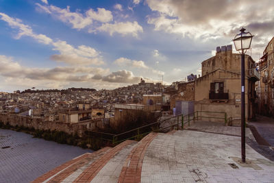 High angle view of buildings in town against sky