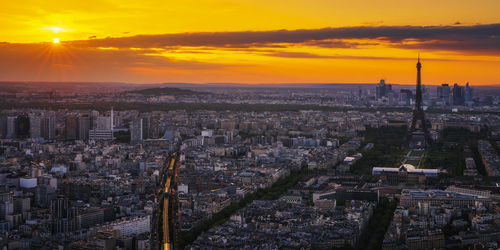 Aerial view of paris cityscape against sky during sunset