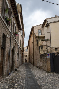 Narrow alley amidst buildings in city