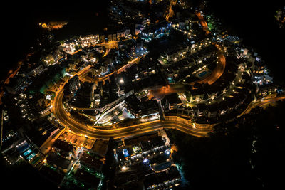 High angle view of illuminated buildings in city at night