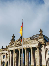 Low angle view of flags against sky