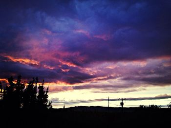 Silhouette of landscape against cloudy sky