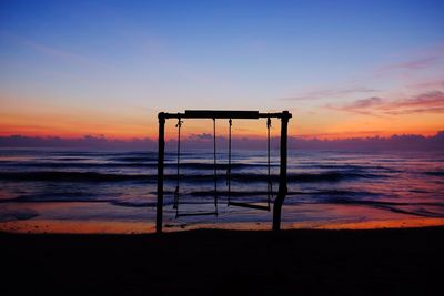 Scenic view of beach against sky during sunset