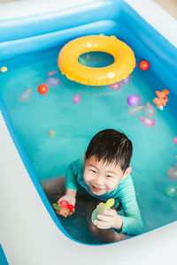 High angle view of boy playing with toy