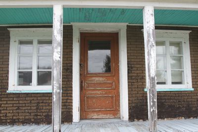 Balcony and entrance of house with asbestos brick