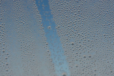 Full frame shot of wet glass during winter