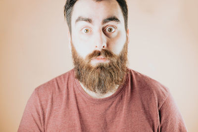 Portrait of young man against wall