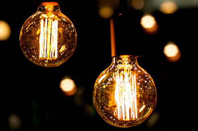 Close-up of illuminated light bulbs at night