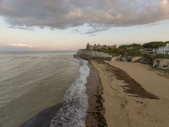 Scenic view of beach against sky during sunset