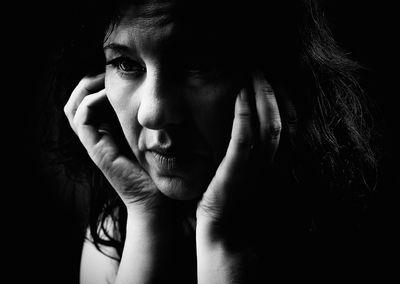 Mature woman sitting in darkroom