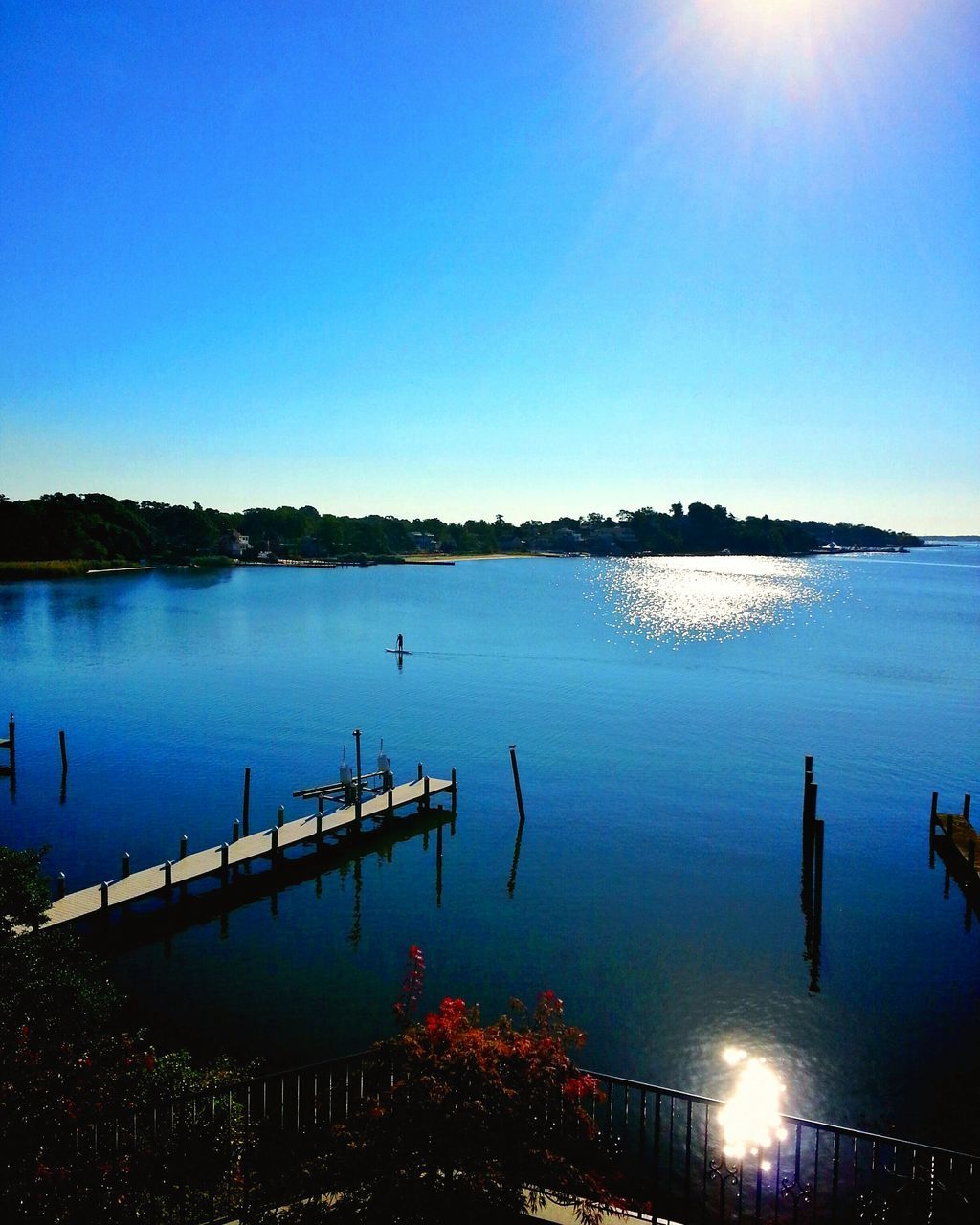 water, reflection, blue, clear sky, illuminated, copy space, sea, waterfront, scenics, lake, tranquil scene, tranquility, sky, built structure, silhouette, beauty in nature, nature, architecture, idyllic, outdoors