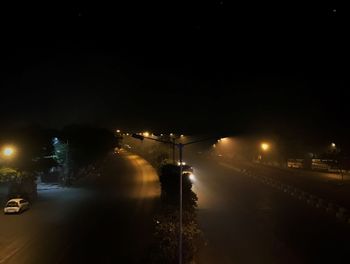 Illuminated city against sky at night