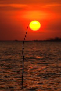 Scenic view of sea against romantic sky at sunset