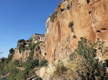 Low angle view of rock formation against sky