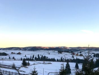 Scenic view of field against clear sky during winter