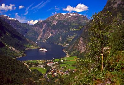 Scenic view of lake and mountains against sky