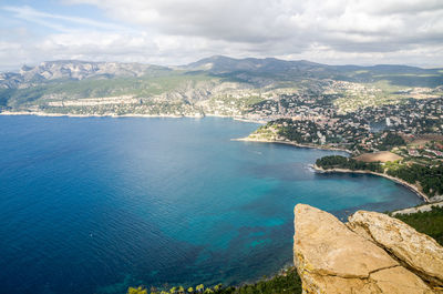 High angle view of sea and mountains against sky