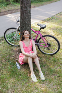 Portrait of young woman sitting on field