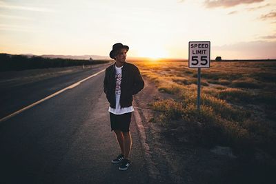 Woman standing at sunset