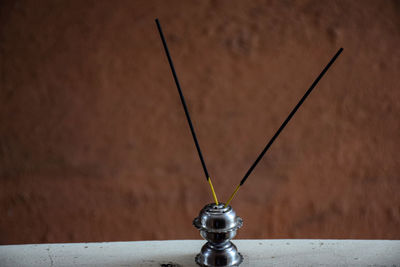 Close-up of electric lamp against wall
