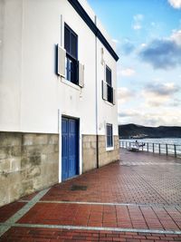 Exterior of building by street against sky