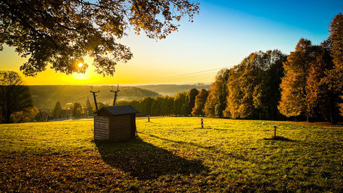 Scenic view of field against sky during sunset