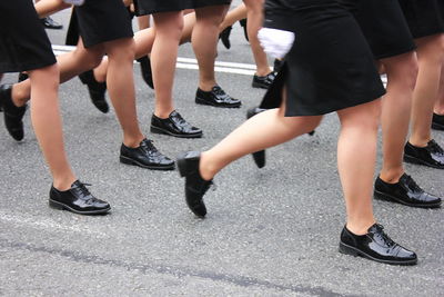 Low section of people walking on street