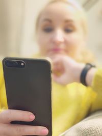 Midsection of woman using mobile phone