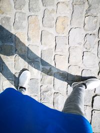 Low section of man standing on footpath