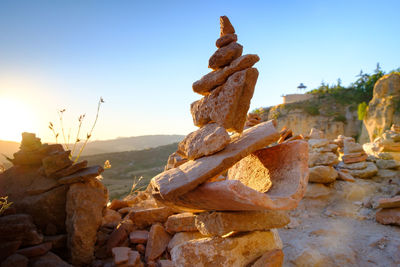 Stack of rocks on land against sky