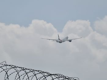 Low angle view of airplane flying in sky