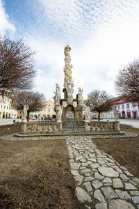 Statue of historic building against cloudy sky