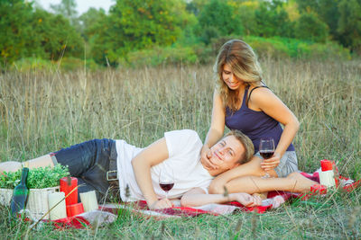 Smiling young woman lying on field