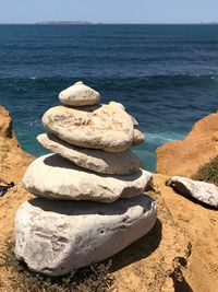 Stack of rocks on beach against sky