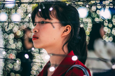 Close-up portrait of a young woman looking away