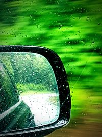 Close-up of wet car window during rainy season