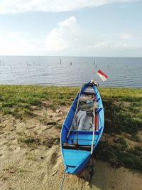 Nautical vessel on beach against sky