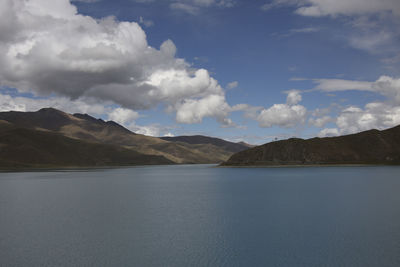 Scenic view of sea and mountains against sky