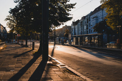 View of railroad tracks by street in city