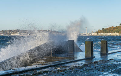 Waves crash on the waterfront at alki beach in west seattle, washington.