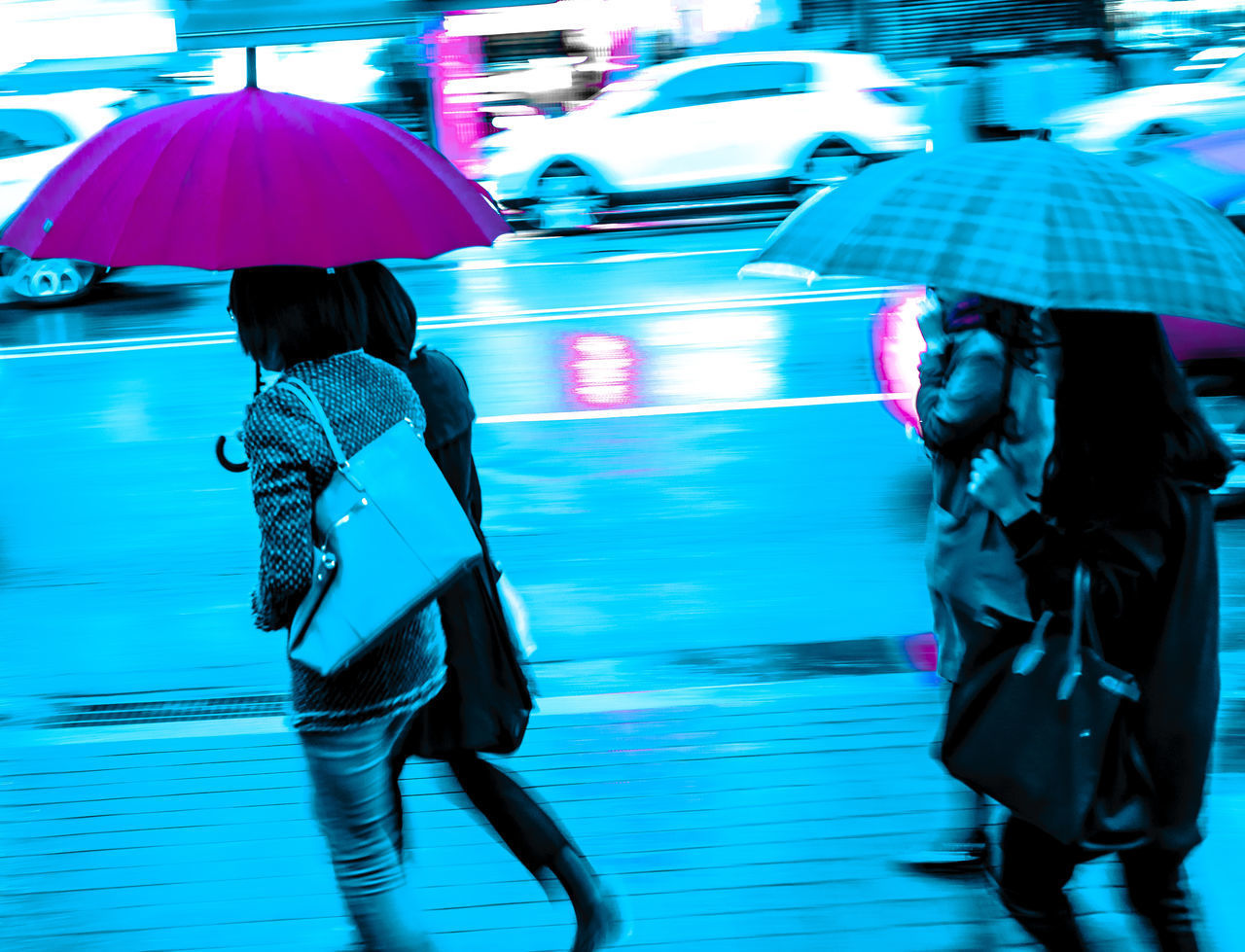 REAR VIEW OF WOMEN WALKING AT NIGHT