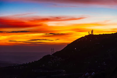 Scenic view of silhouette mountains against sky during sunset