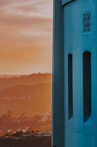 Scenic view of building against sky during sunset