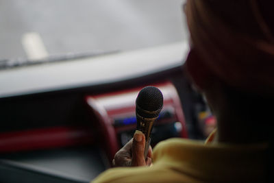 Close-up of woman holding microphone