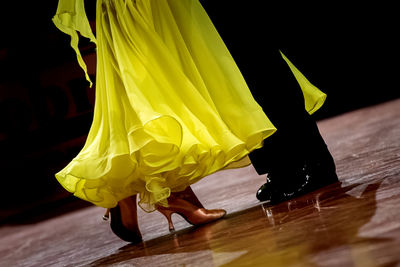 Low section of woman dancing on hardwood floor