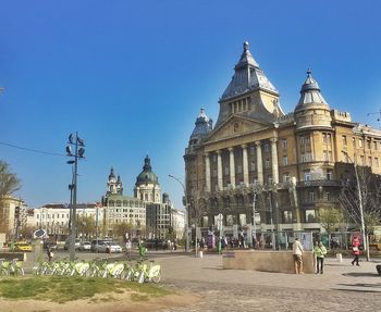 View of buildings against clear blue sky